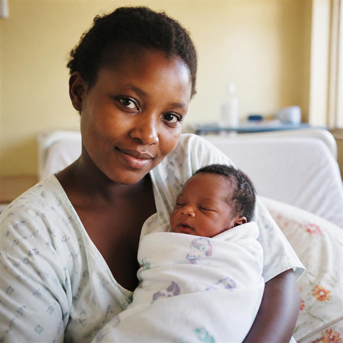 Mother holding her newborn baby in the maternity ward